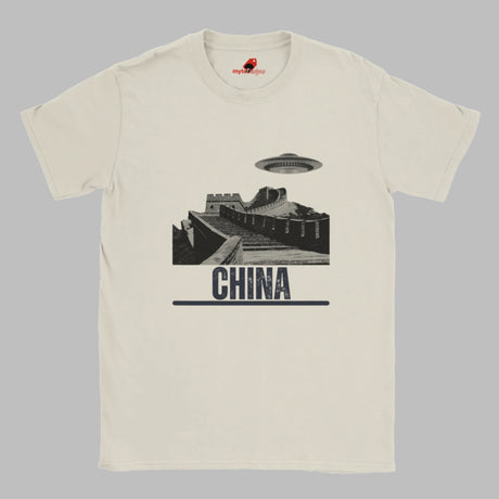 Sand coloured T-shirt with a vintage black-and-white Great Wall of China illustration and a UFO hovering above it, labeled ‘CHINA,’ designed by MytsDesigns.com”

