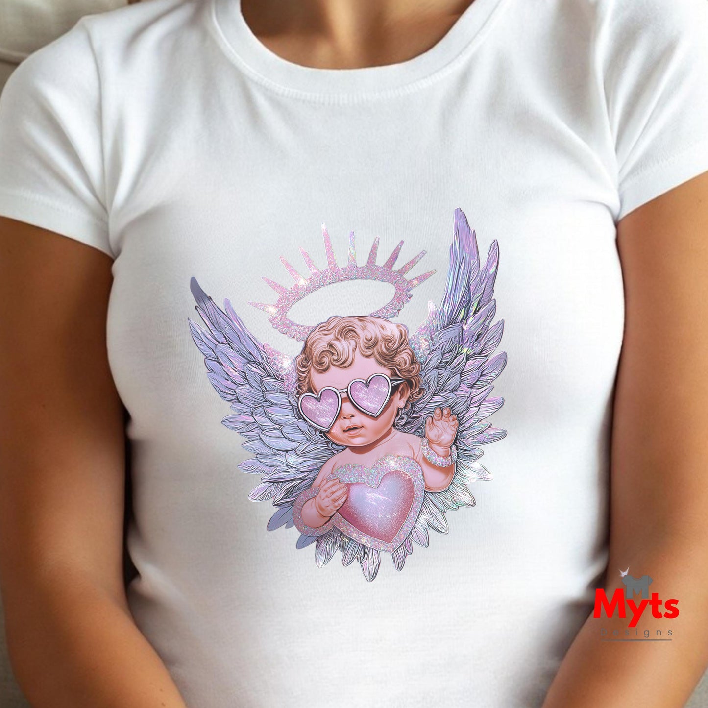 White t-shirt with an angel design holding a heart, wearing sunglasses, on a person.