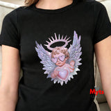 Black t-shirt with an angel graphic design featuring wings and a halo, held by a heart, worn by a person.