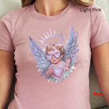 Light pink t-shirt with an angel design featuring wings and a heart, worn by a person.
