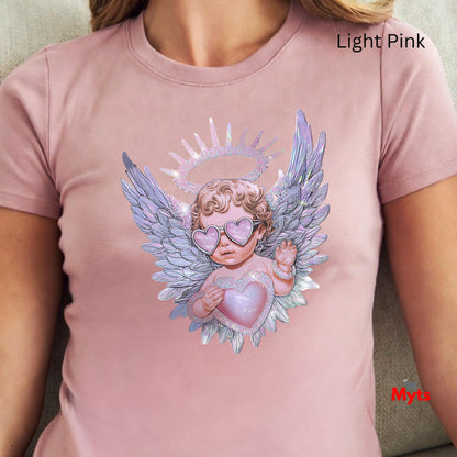 Light pink t-shirt with an angel design featuring wings and a heart, worn by a person.