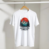 White t-shirt with 'Adventure Awaits' graphic on a hanger against a plain background