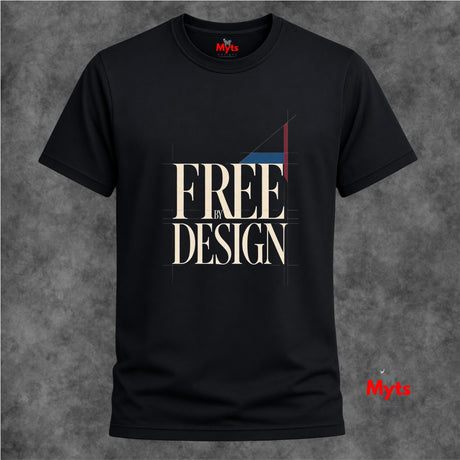 A black short-sleeve T-shirt with a graphic print reading 'FREE BY DESIGN' in beige, white, and red, displayed against a textured gray background.