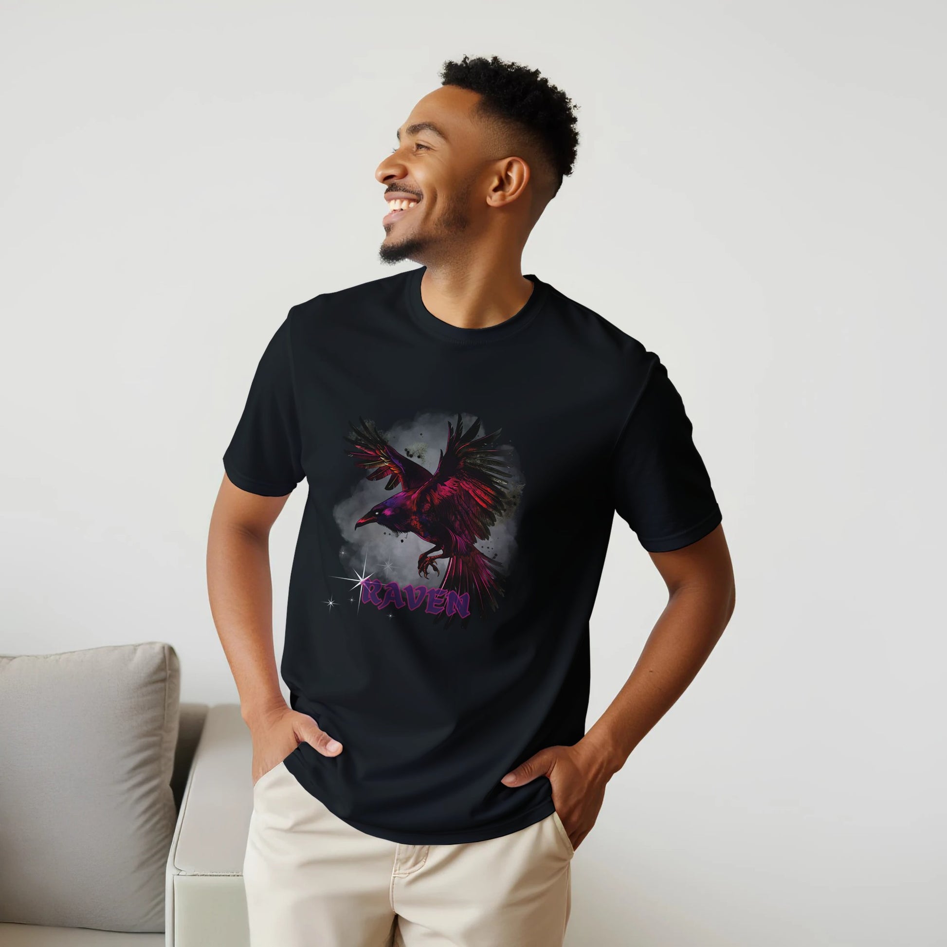 Man wearing a black t-shirt with a graphic design of a bird and the word 'Queen' on a light gray background.