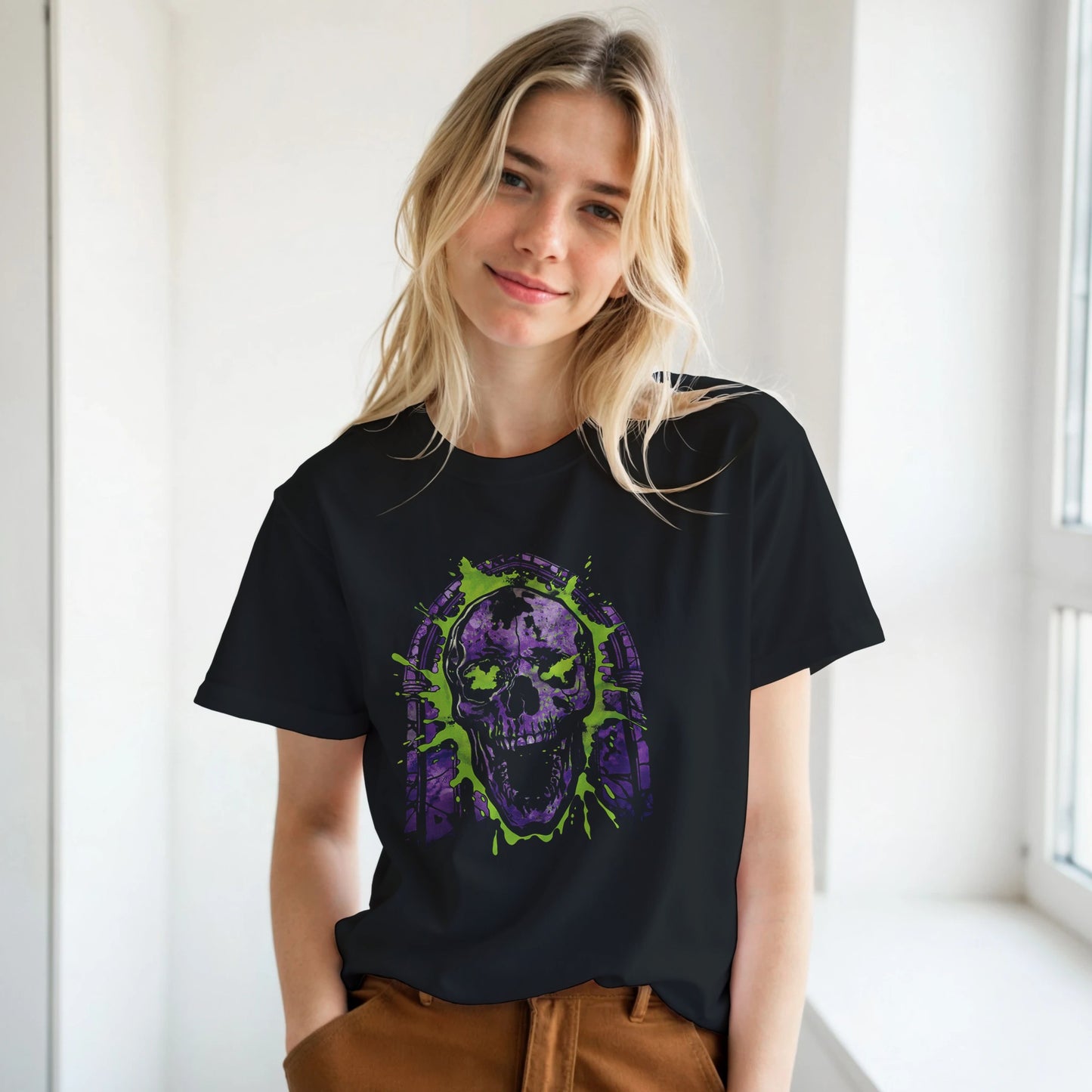 Person wearing a black t-shirt with a purple and green skull design.