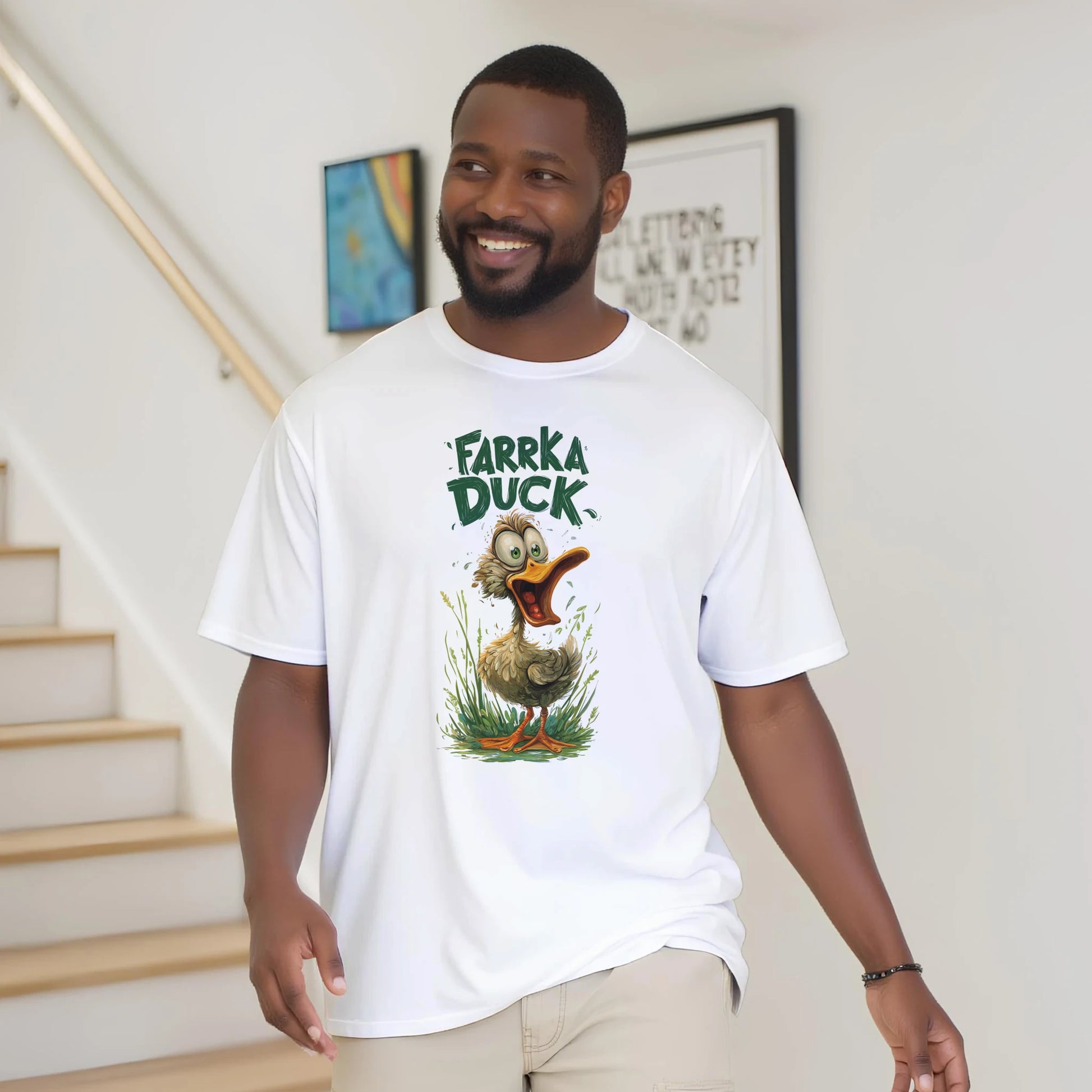 Man wearing a white t-shirt with 'Farka Duck' graphic design indoors.