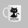 A white ceramic mug with a printed black cat design, text, and a barcode.