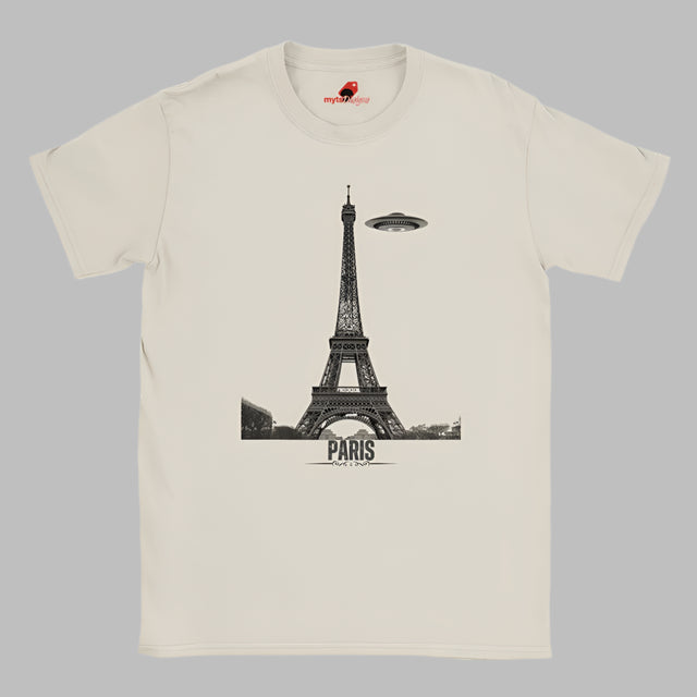 Front view of a white soft casual tee featuring a whimsical graphic of the Eiffel Tower with a retro‑style spaceship orbiting it, printed on ultra‑soft Gildan 64000 cotton.