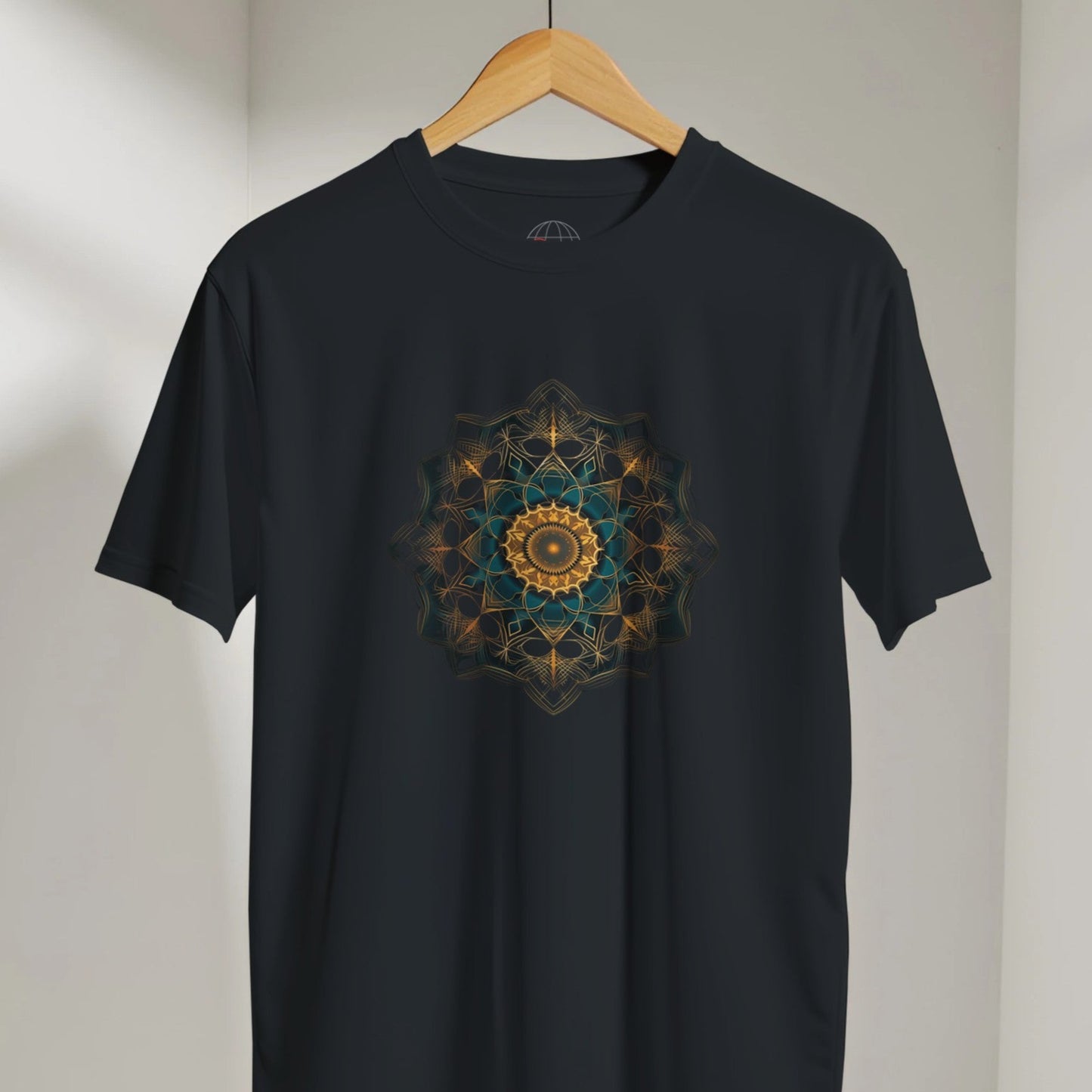 Black t-shirt with a colorful mandala design on a hanger against a neutral background