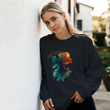 A woman leans against a white wall wearing a black crewneck sweatshirt with a colorful graphic of a wolf and the text 'NEW EVOLUTION'.