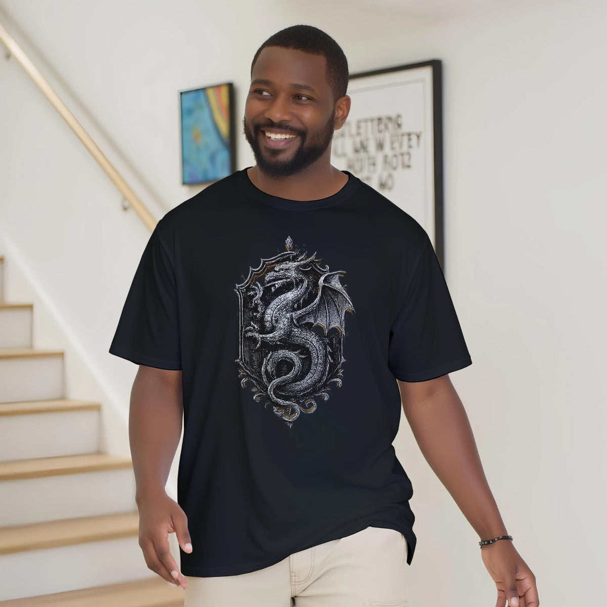 Man wearing a black t-shirt with a dragon design indoors.