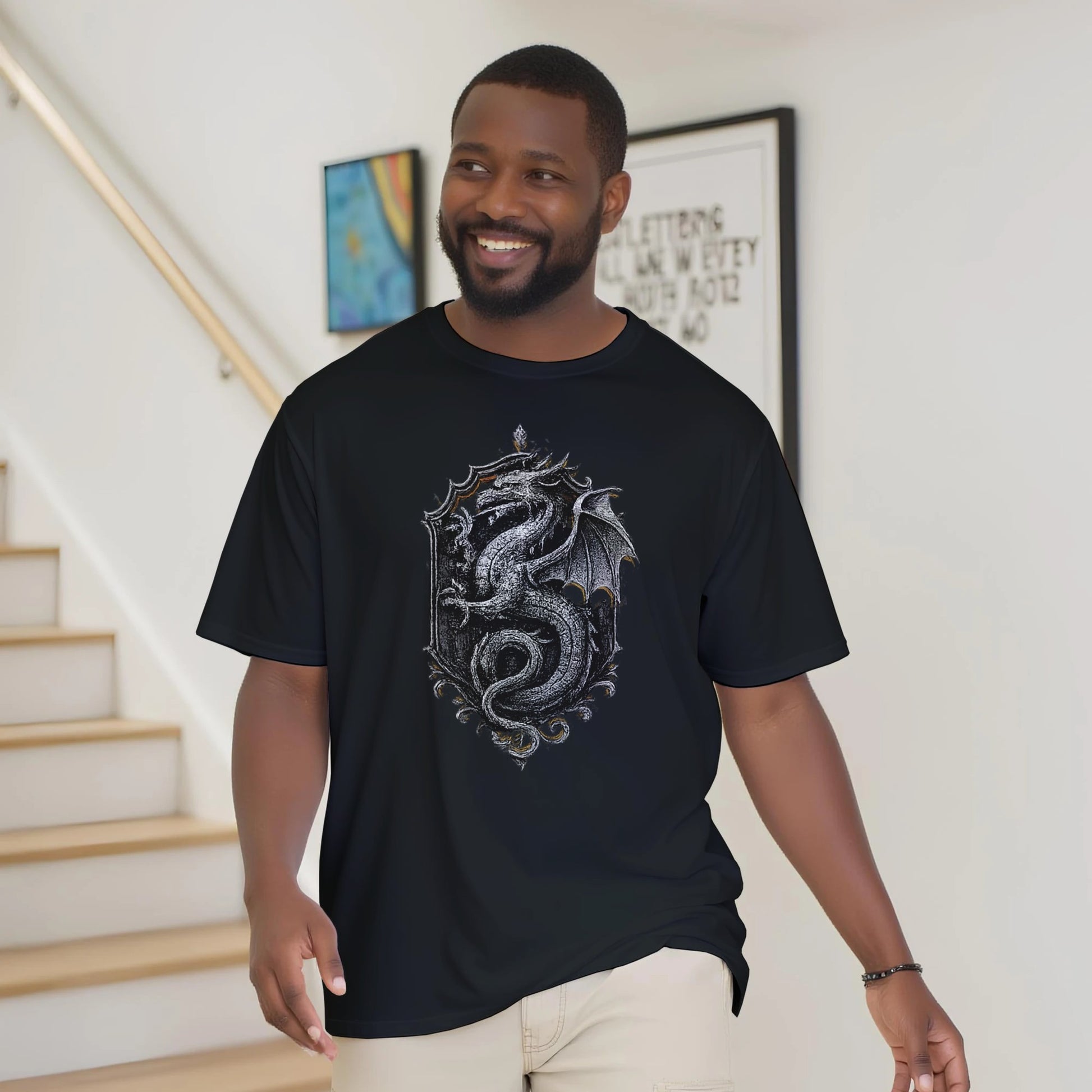 Man wearing a black t-shirt with a dragon design indoors.