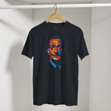 Black t-shirt with colorful graphic of a face on a hanger against a white wall.