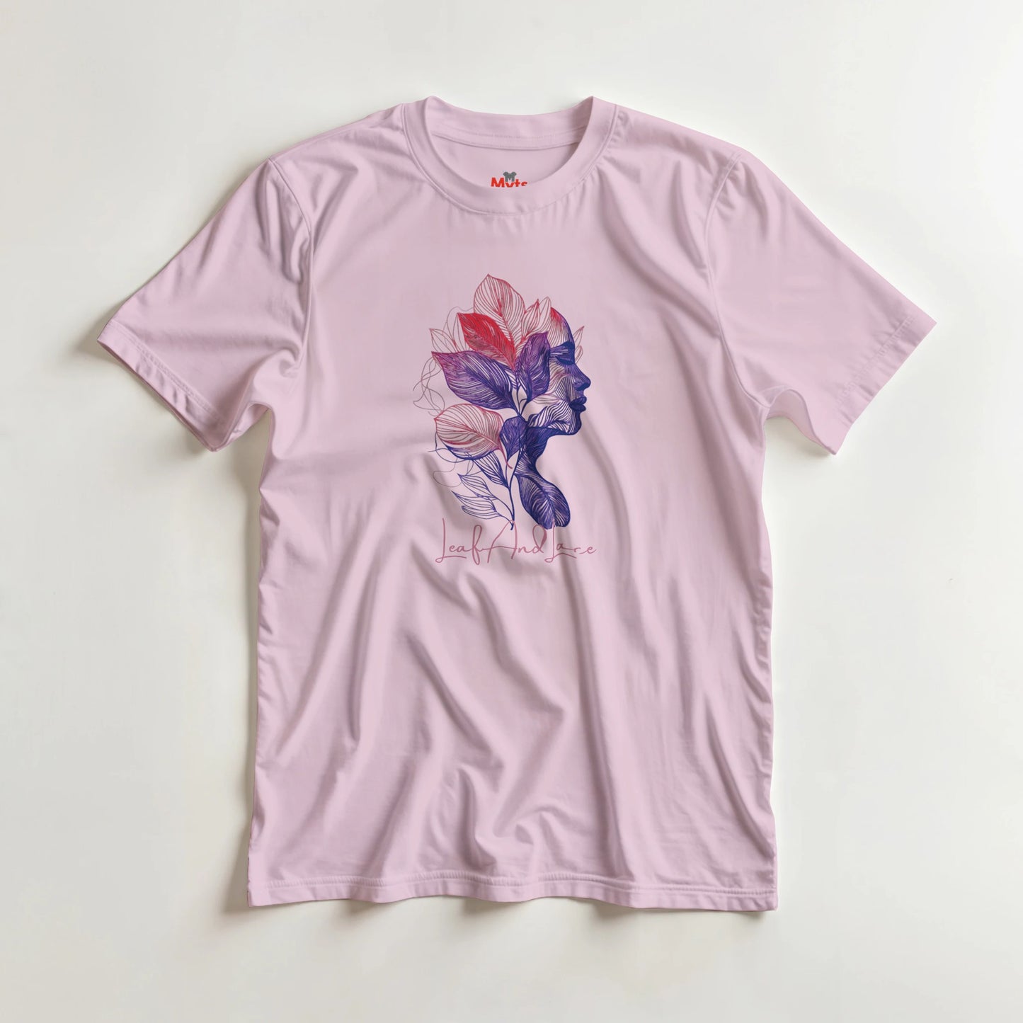 Pink t-shirt with a colorful graphic design on a light gray background