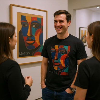 A man wearing a Matisse t-shirt is standing in front of a colorful Matisse painting in an art gallery.