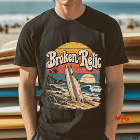 Man wearing black Broken Relic vintage surf graphic T-shirt at the beach