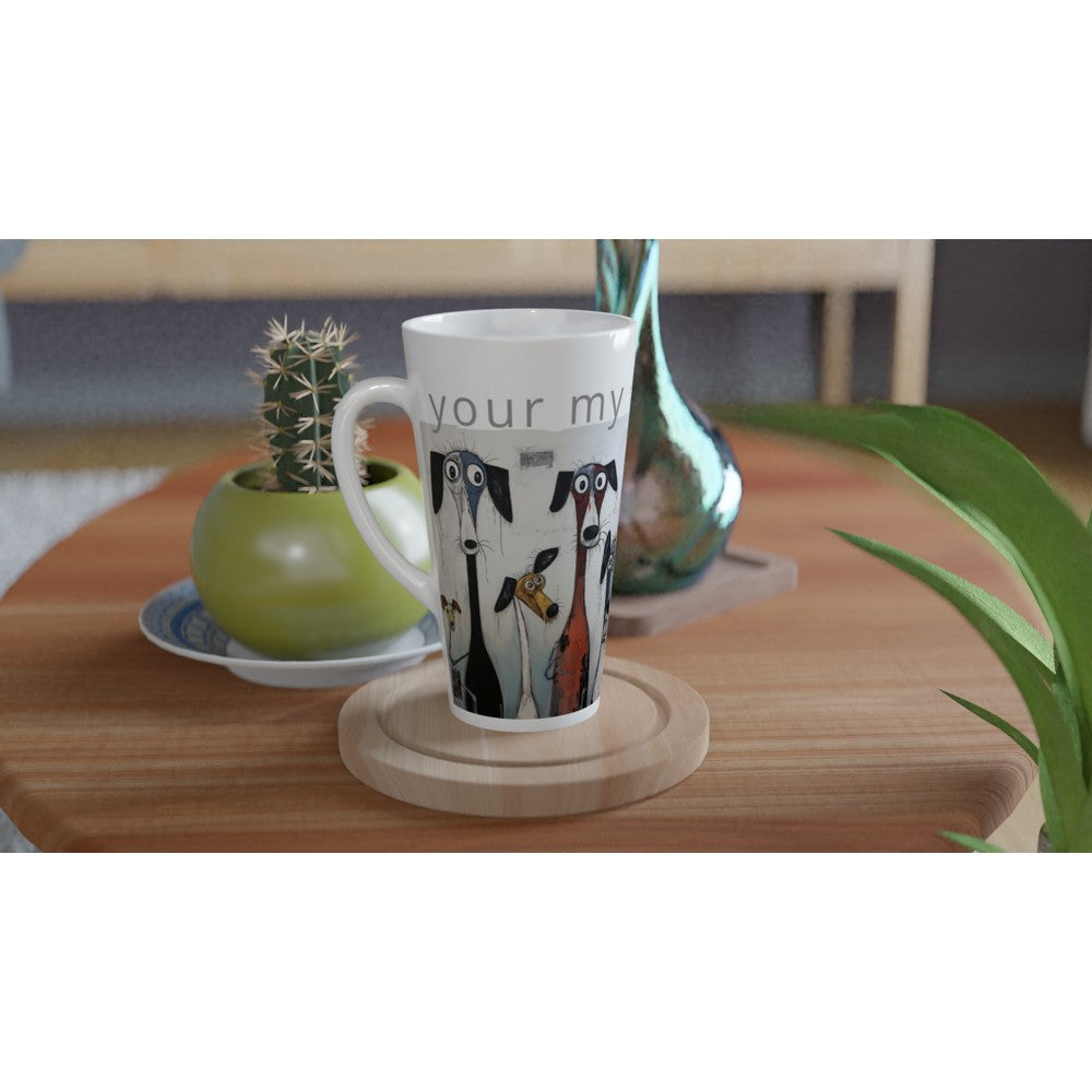 A white ceramic mug with a colorful illustration of penguins and the text 'your my' sits on a round wooden coaster on a wooden table, styled with a small potted cactus and a green plant in a home setting.