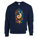 A navy blue crewneck sweatshirt featuring a colorful graphic print of a nautilus shell, starfish, and seashells on the front, displayed against a solid white background.