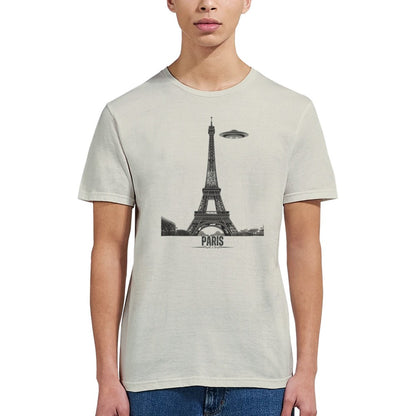 Front view of a sand soft casual sand tee featuring a whimsical graphic of the Eiffel Tower with a retro‑style spaceship orbiting it, worn by a young woman.