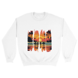 A white unisex sweatshirt featuring a vibrant tropical sunset design with silhouettes of surfers walking along a beach. The graphic includes palm trees, an orange and pink sky, and artistic brushstroke edges, creating a modern coastal vibe. Ideal for beach lovers, surfers, and casual fashion fans.

