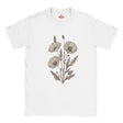 A white short-sleeve crewneck t-shirt featuring a central graphic of three muted beige poppy flowers and leaves. The brand name 'Myts' is printed in red on the inside neck label.