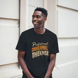 Man wearing a black t-shirt with text standing against a neutral background