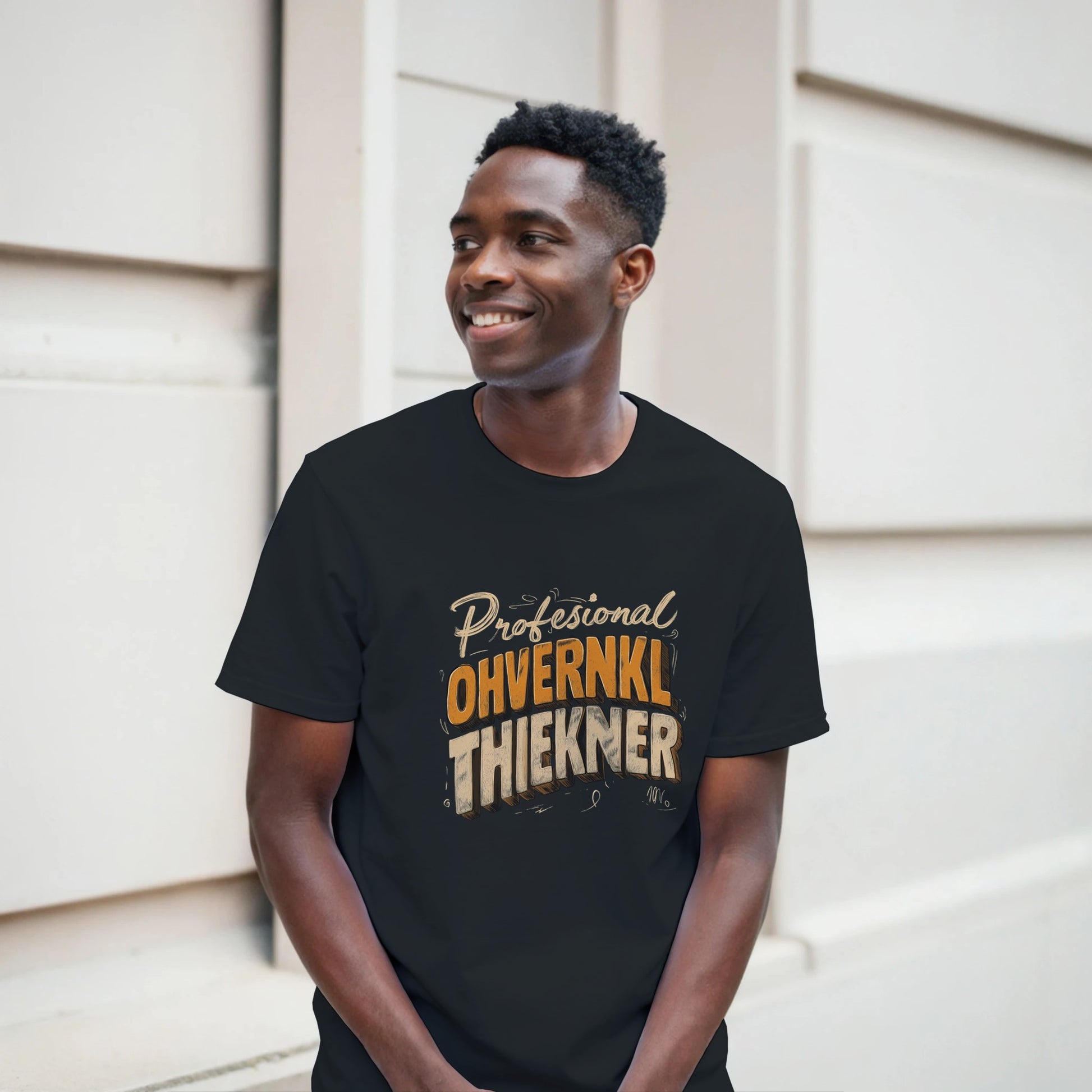 Man wearing a black t-shirt with text standing against a neutral background