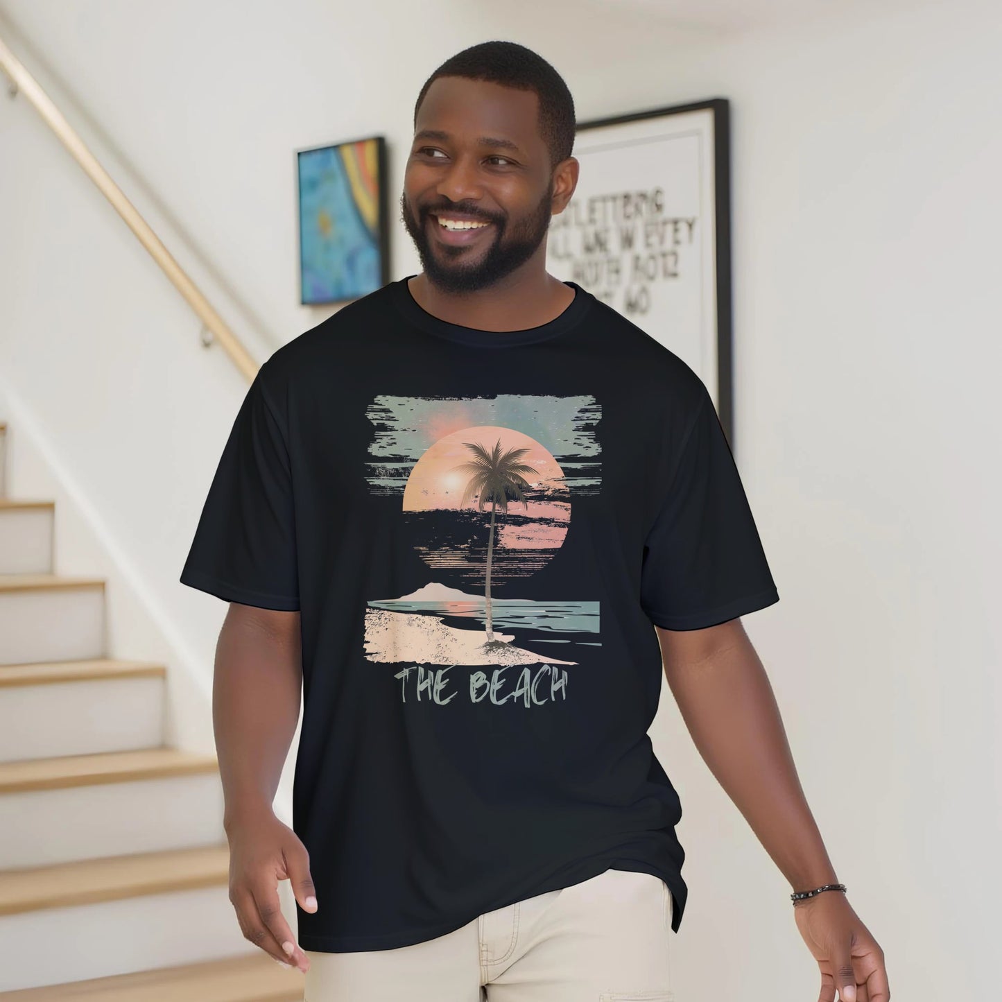 A man wearing the black "The Beach" T-shirt