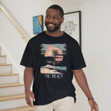 A man wearing the black "The Beach" T-shirt
