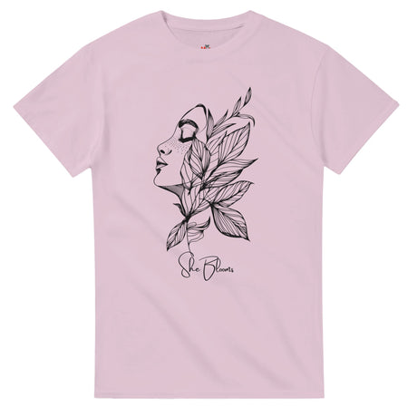 Pink t-shirt with a black floral and face design on a white background