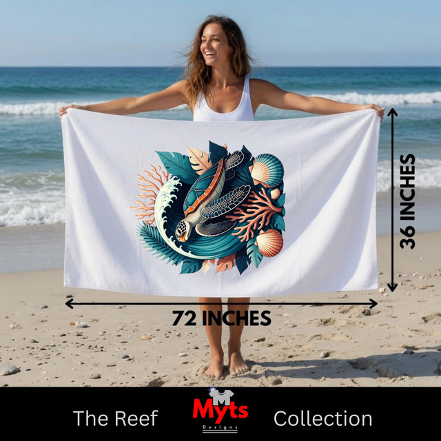 A woman on a beach holds up a large white towel or beach wrap featuring a colorful printed design of a fish, shell, and coral. Measurement arrows and text indicate the towel is 72 inches by 36 inches.