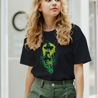 Woman wearing a black t-shirt with a graphic design and green pants in an indoor setting.