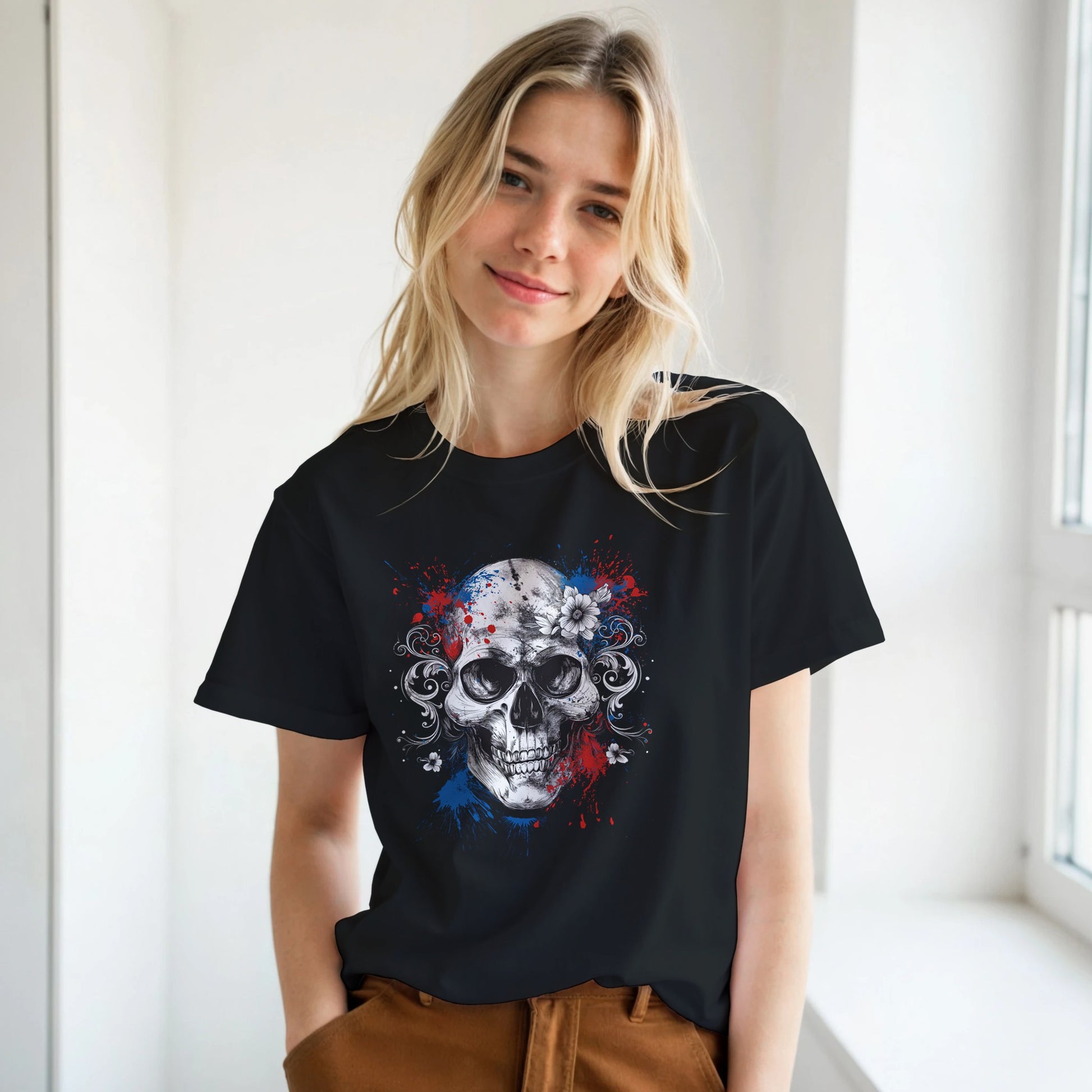 Person wearing a black t-shirt with a skull design in a room with a window.