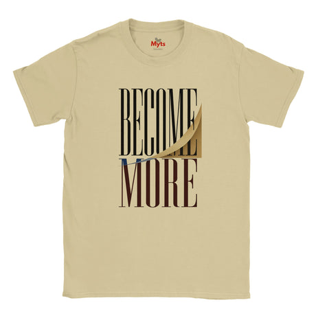 A sand-colored crewneck t-shirt with a graphic print on the front reading 'BECOME MORE' in black and brown block letters, featuring a stylized peeled-back paper effect. The brand name 'Myts' is visible on the inner neck label.