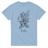 Light blue t-shirt with black artistic design of a face and leaves on a white background