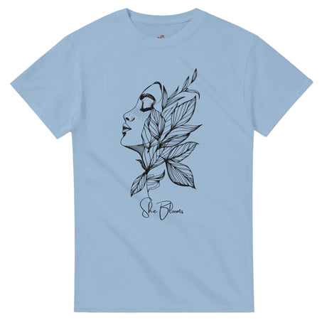 Light blue t-shirt with black artistic design of a face and leaves on a white background