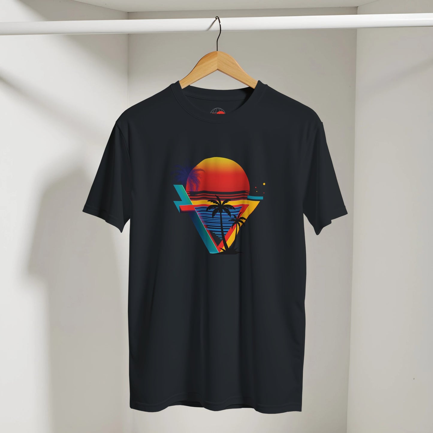 Black t-shirt with colorful geometric design on a hanger against a plain background