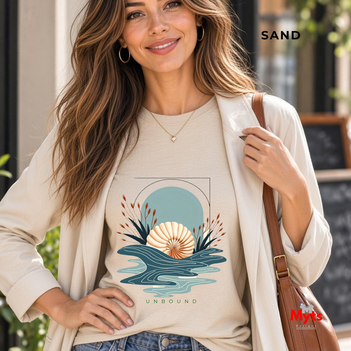 A woman wearing a Sand coloured oceanic design with the word UNBOUND at the bottom