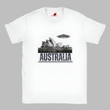 Front view of a white soft casual tee showing the Sydney Opera House sails with a sleek spaceship graphic orbiting overhead, printed on ultra-soft Gildan 64000 cotton.