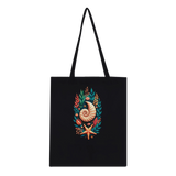 A black canvas tote bag with two shoulder straps, featuring a colorful central graphic of a nautilus shell, starfish, and tropical leaves on a plain white background.