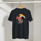 Black t-shirt with 'Ride the Wave' design on a hanger against a white wall