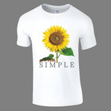 A white crew-neck t-shirt with a bold sunflower graphic and the text 'It's That Simple' printed on the front.