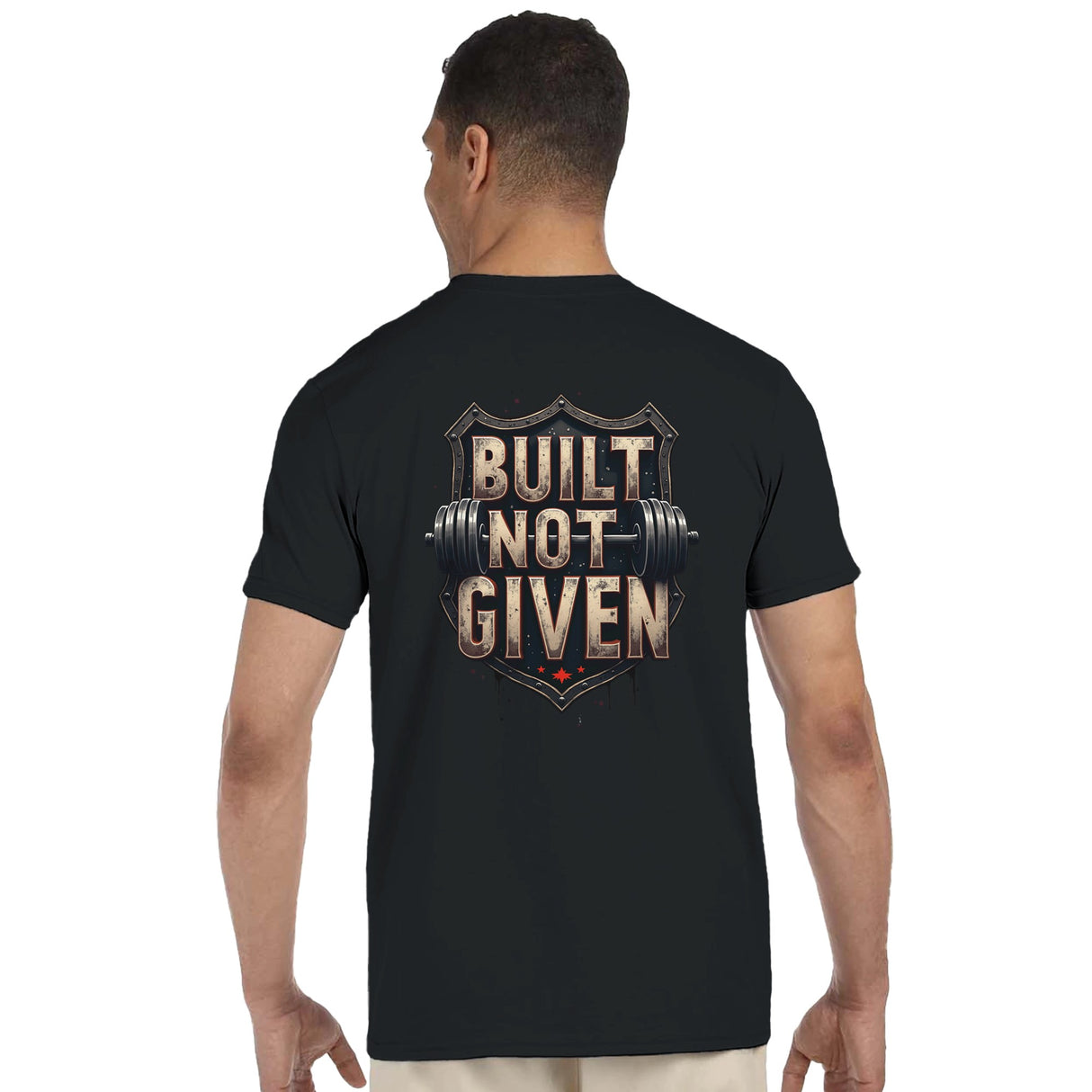 Person wearing a black t-shirt with 'Built Not Given' text and barbell graphic on the back.