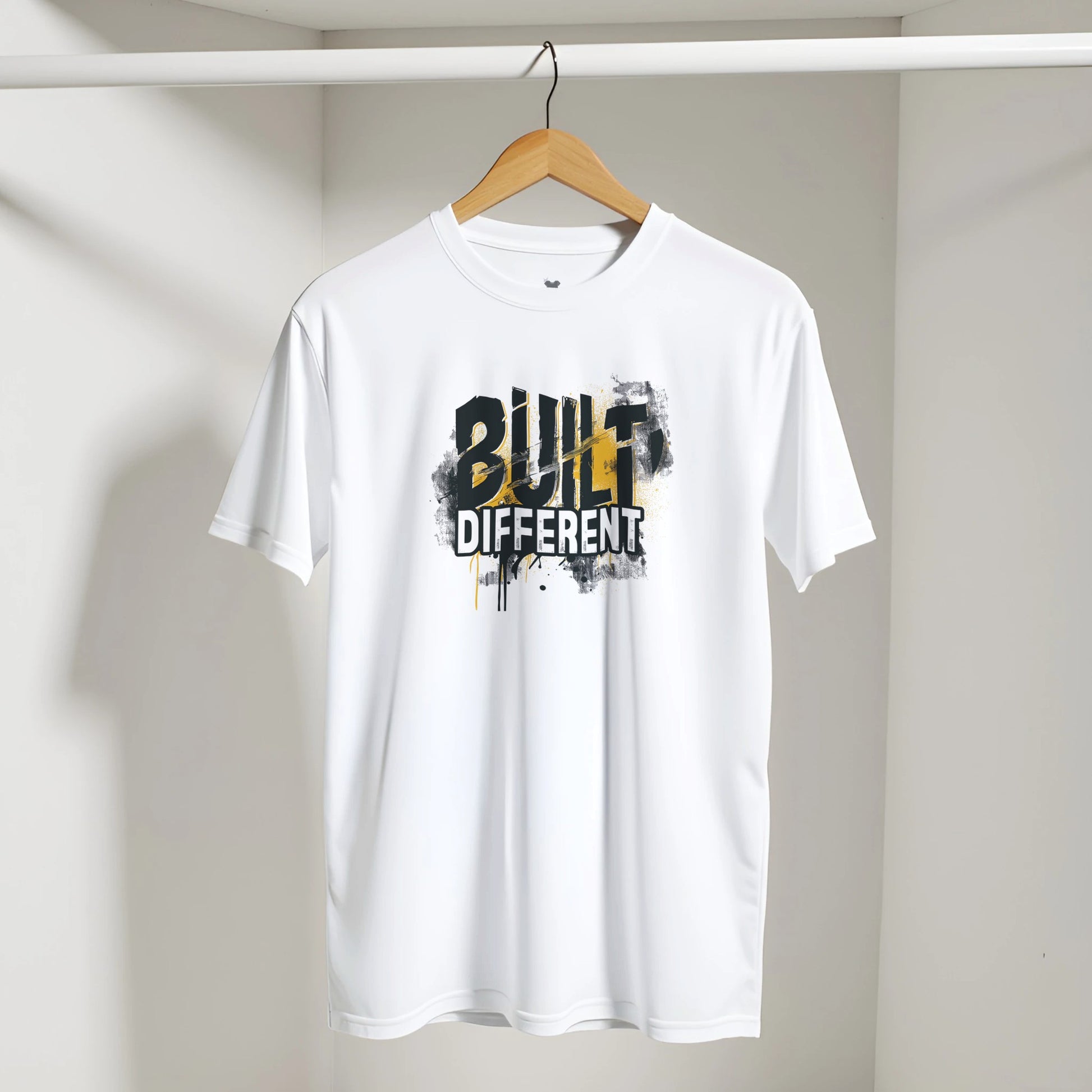 White t-shirt with 'Built Different' text on a hanger against a plain background