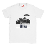 “White T-shirt with a vintage black-and-white Great Wall of China illustration and a UFO hovering above it, labeled ‘CHINA,’ designed by MytsDesigns.com”

