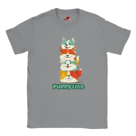 A flat lay grey T-shirt featuring a colorful graphic of four stacked cartoon puppies in teal, orange, cream, and yellow shades with the words “Puppy Love” in playful green text below


