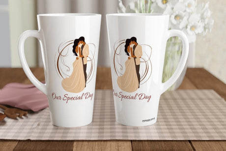 Two white ceramic coffee mugs with a custom illustration of a couple in a wedding dress and the text 'Our Special Day' printed on them, displayed on a checkered placemat on a wooden table.