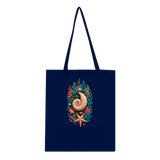 A navy blue canvas tote bag with long shoulder straps, featuring a central graphic print of a nautilus shell, starfish, and botanical elements in orange, teal, and cream, set against a plain white background.