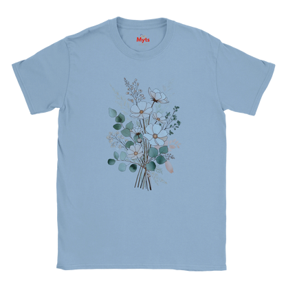 A light blue short-sleeve crewneck t-shirt featuring a central graphic of a watercolor-style floral bouquet with green, white, and peach blossoms. The brand name 'Myts' is printed in red on the inside neck label.