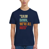 girl wearing A navy retro styled t-shirt, featuring distressed lettering "Calm Down, We're All Nuts" on a white background